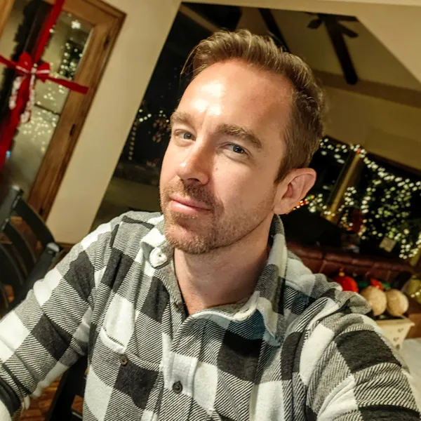 Professional portrait of Roy Dawson IV, Systems Architect and AI Consultant, in a cinematic, low-key lighting style.
